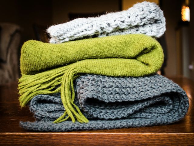 A bundle of 3 scarves, coloured white, green and grey.